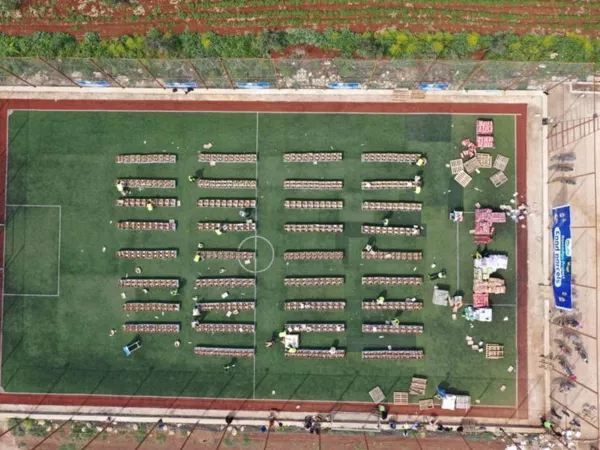 Group photo of volunteers and recipients with baskets